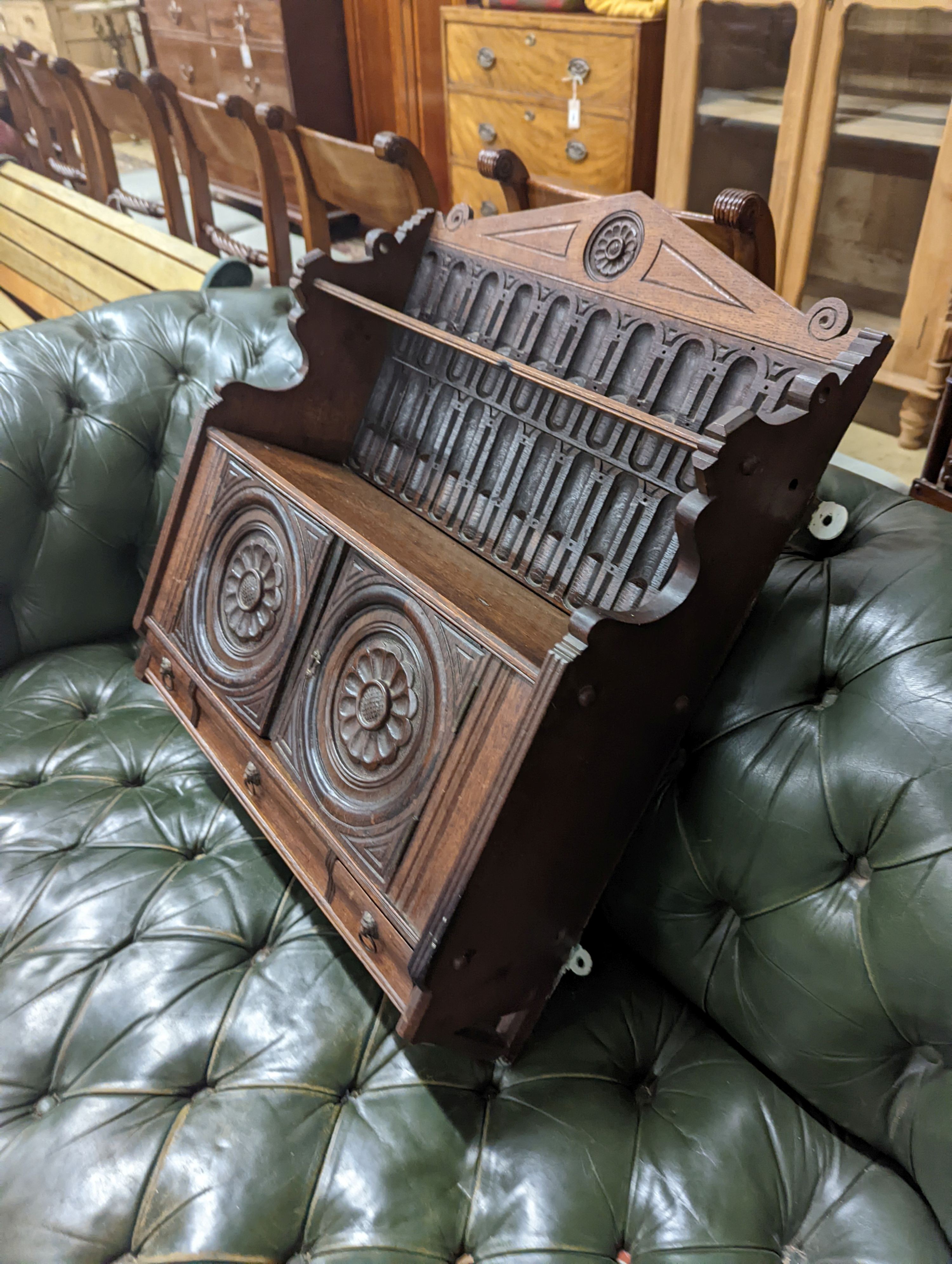 A Victorian carved oak Arts and Crafts wall cabinet, width 55cm, depth 18cm, height 68cm